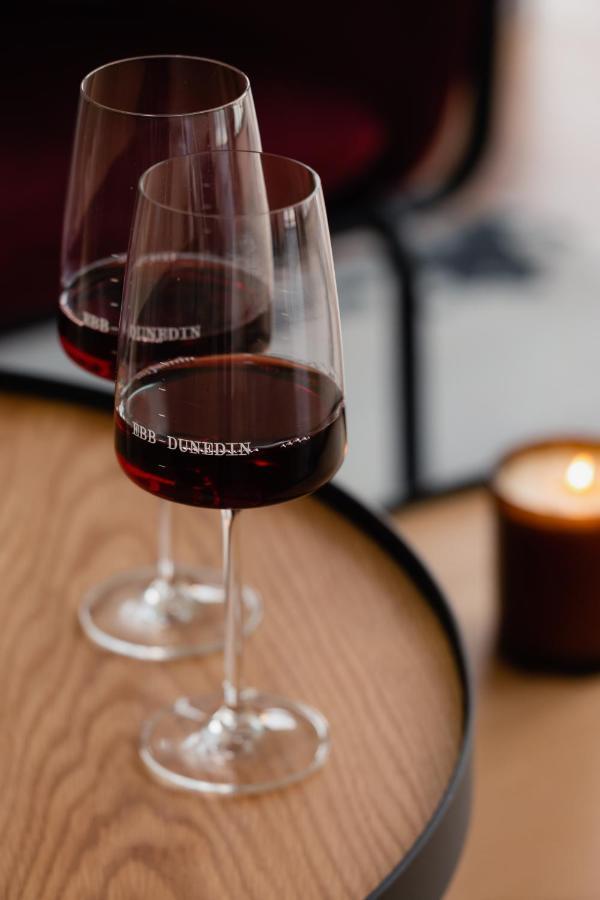 Ebb-Dunedin Exterior photo A glass of red wine